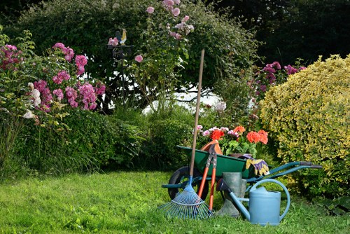 Team preparing tools for hedge trimming in Putney